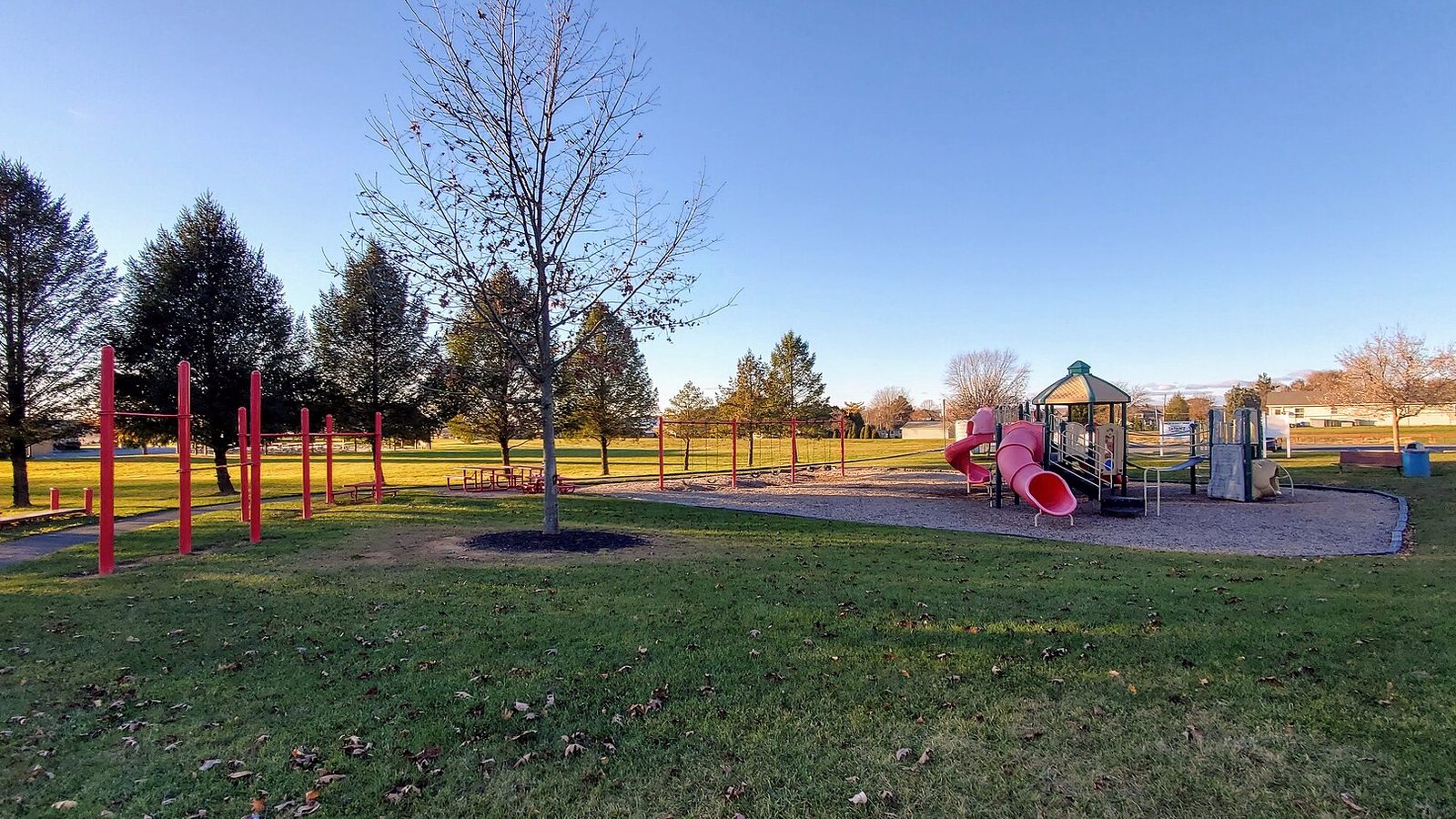 A small neighborhood playground with climbing equipment on a grassy lot, similar to the playground at Conway Park in Abington, Pennsylvania
