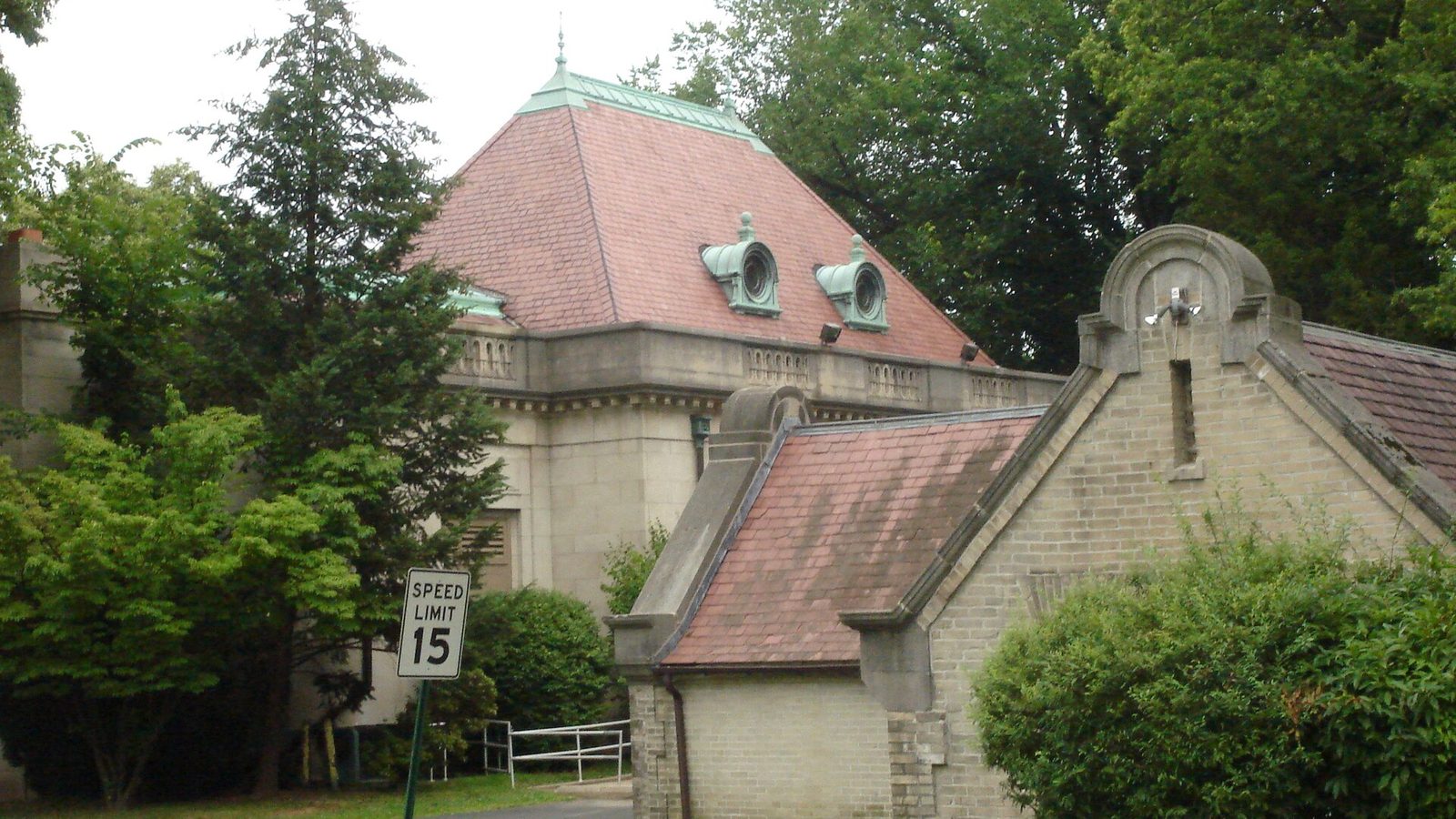 The stone Curtis Hall building surrounded by mature trees at Curtis Arboretum in Wyncote, Pennsylvania