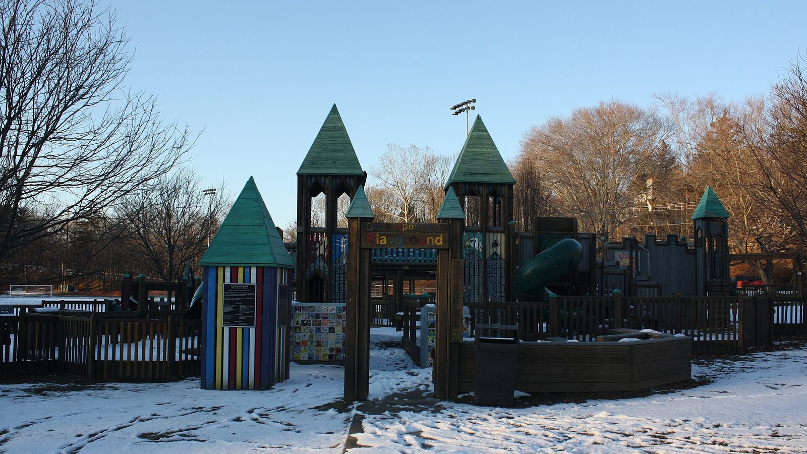 The wooden castle style play structure dusted with snow at Wall Park in Elkins Park, Pennsylvania